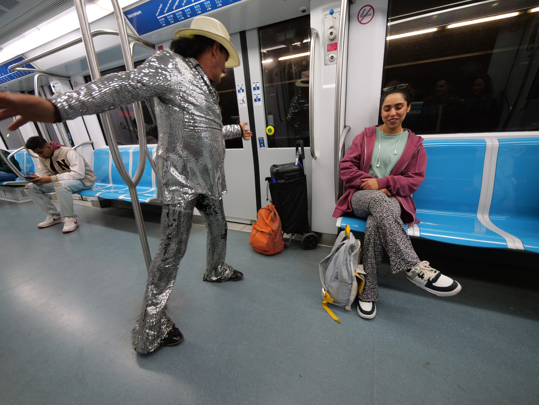 The performer dances close as the passenger laughs
