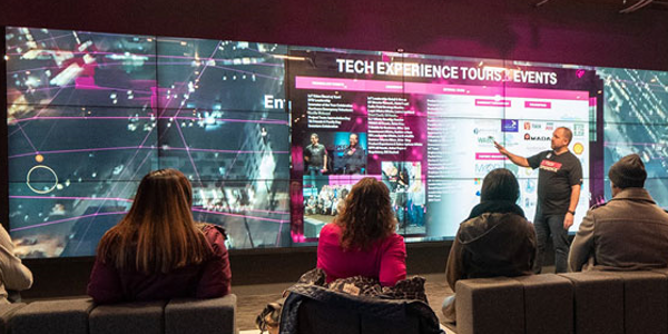 Tech Experience Tours and Events presentation on the video wall